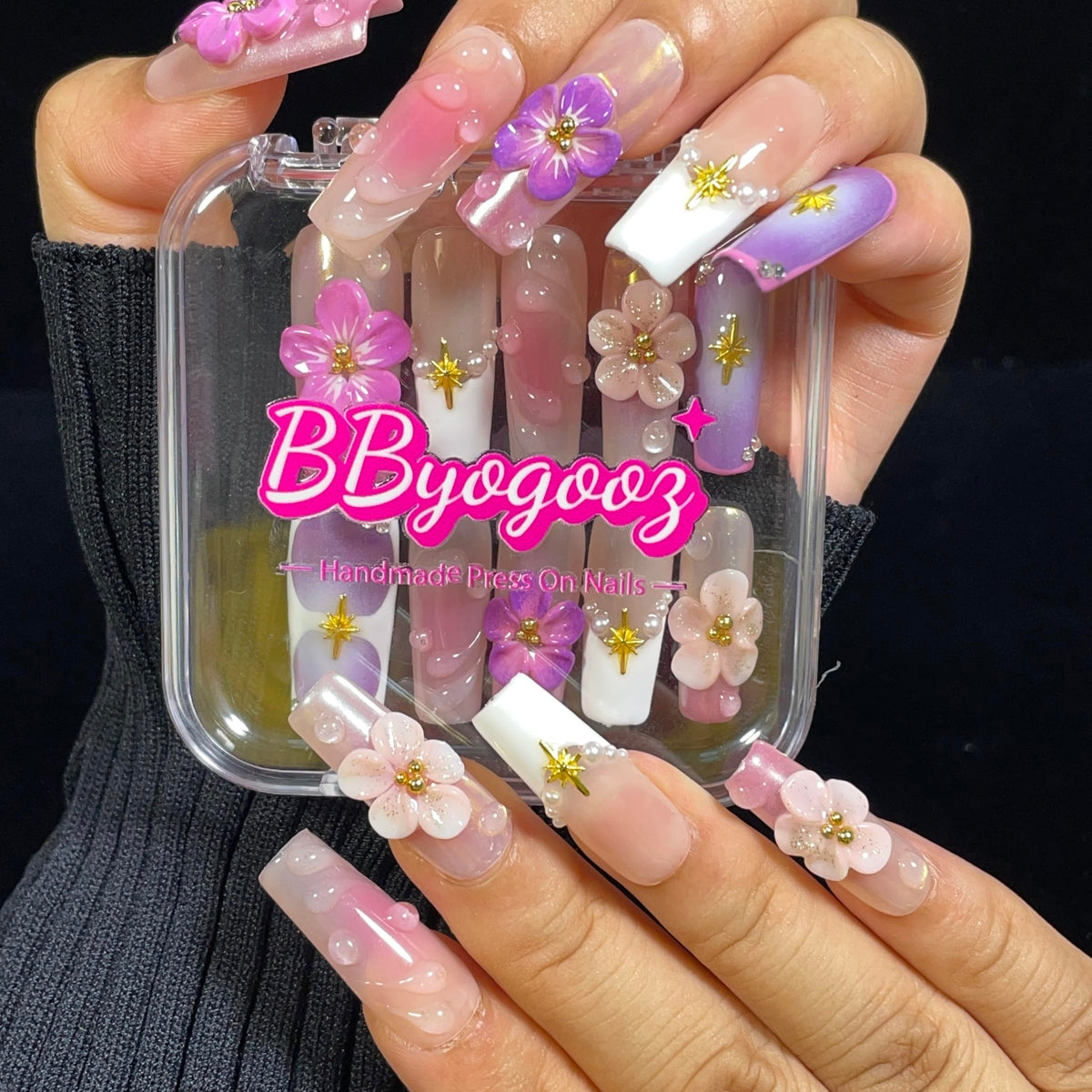 BByogooz nails with gold stars and pearls highlight delicate detail and luxury appeal.