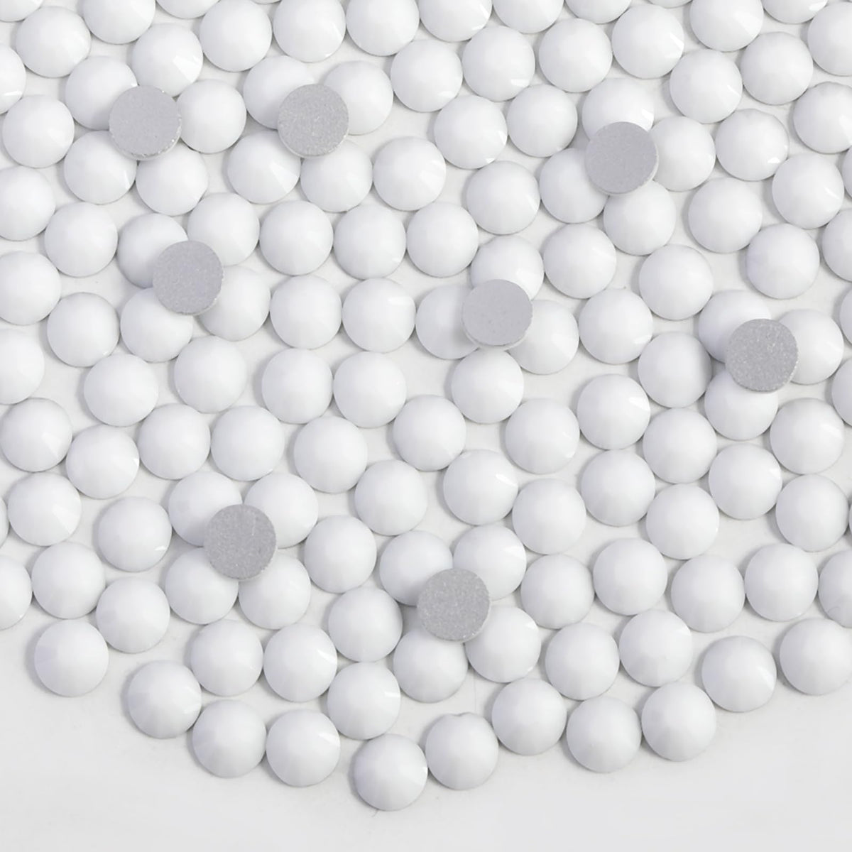Beadsland flat-back glass rhinestones showing precise cuts for glue adhesion.