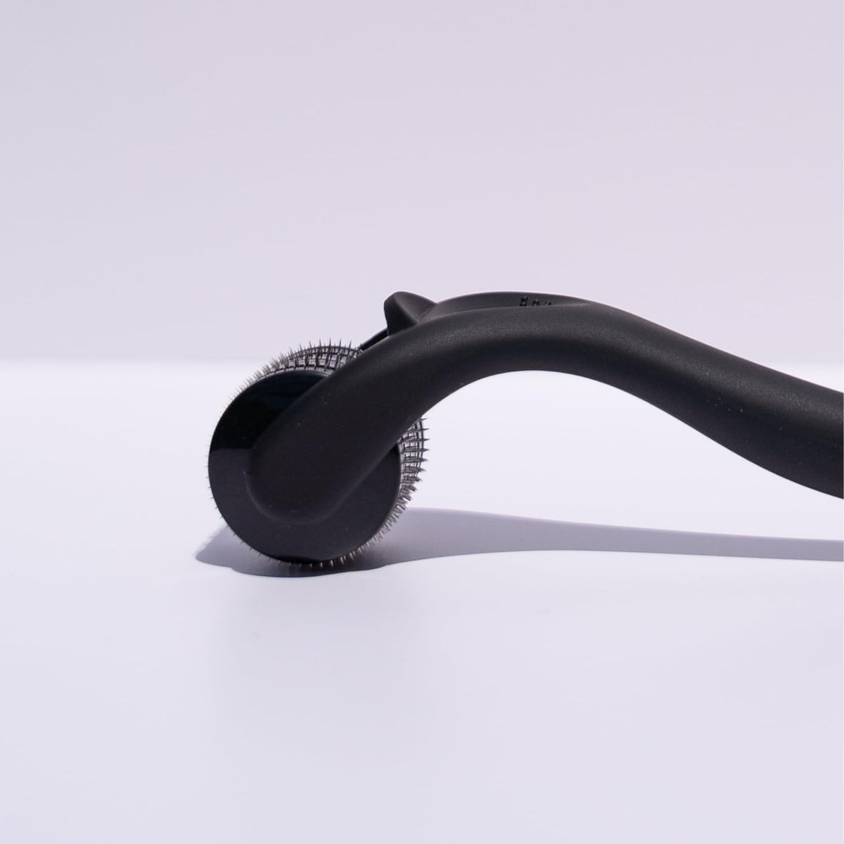 Beautimate microneedle derma roller used on beard area for grooming routines.