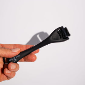 Hands rolling gently on skin with Beautimate tool.