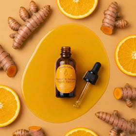 Beauty Glow turmeric vitamin C face oil jar on vanity showcasing compact 1 oz size.