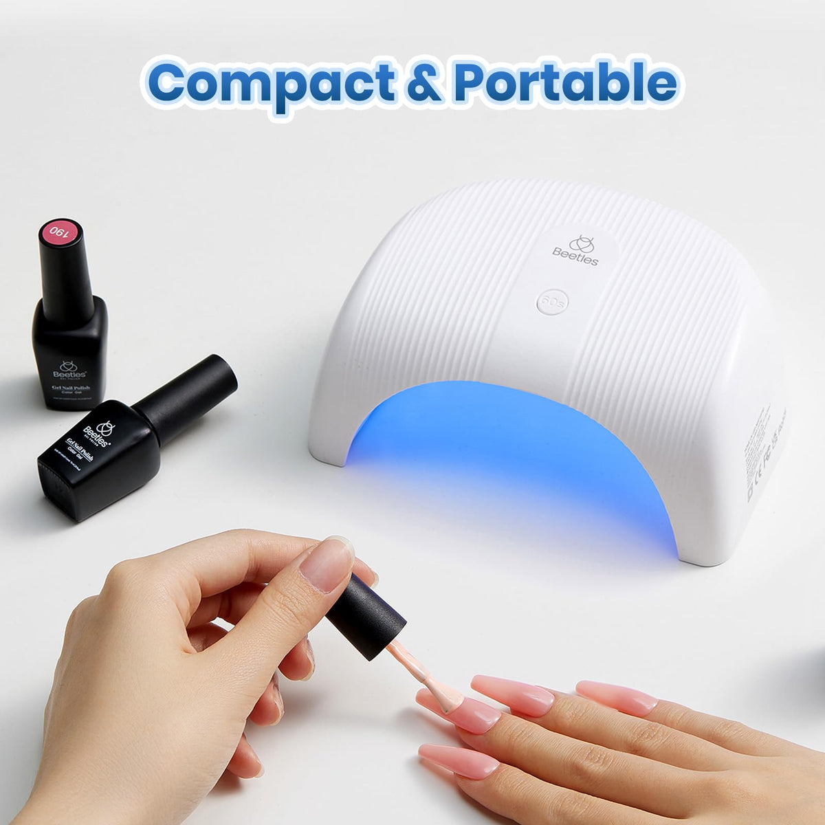 Beetles lamp in use on fingers for quick at-home manicures