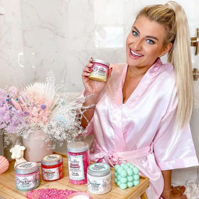 Hands applying Bella and Bear Goddess Sugar Scrub for even coverage.