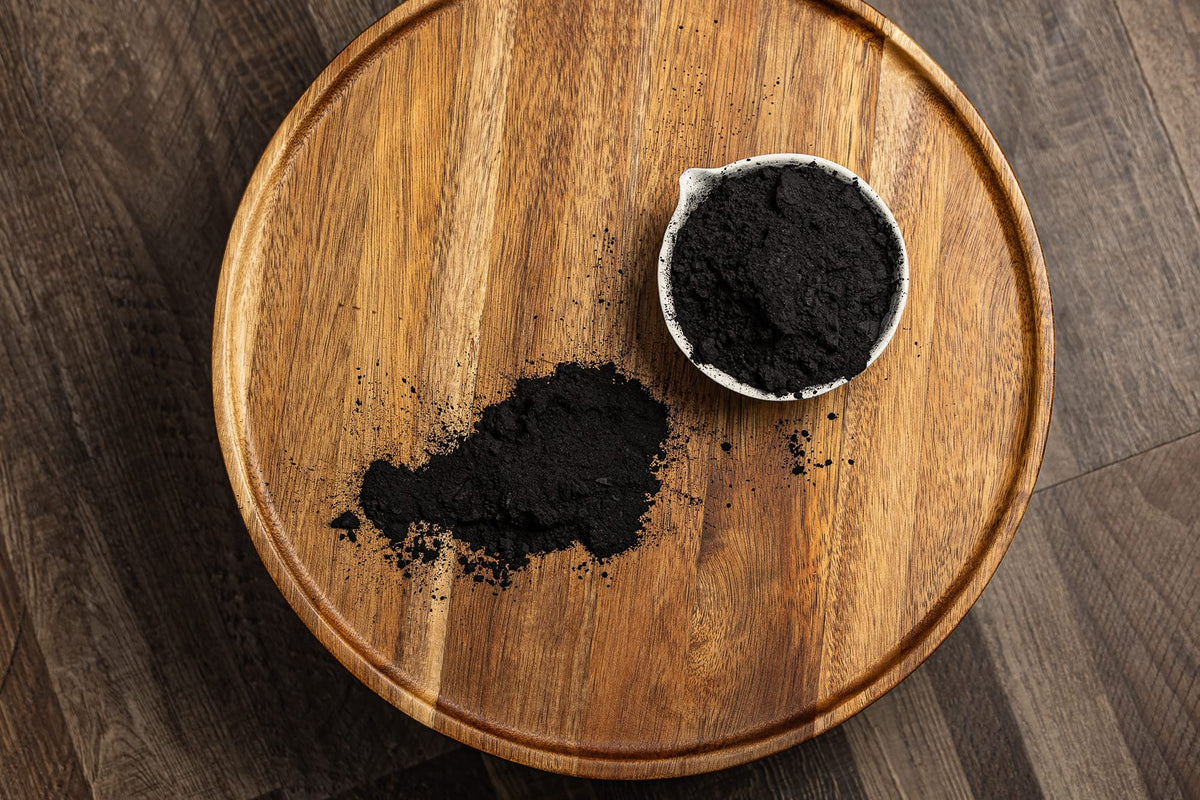 Belle Chemical coconut activated charcoal powder used in a facial scrub setup