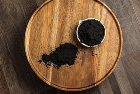Belle Chemical coconut activated charcoal powder used in a facial scrub setup