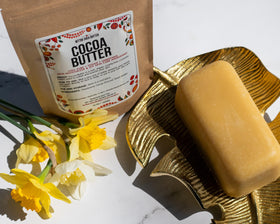 Close-up of Better Shea Butter unrefined cocoa butter melting on skin.