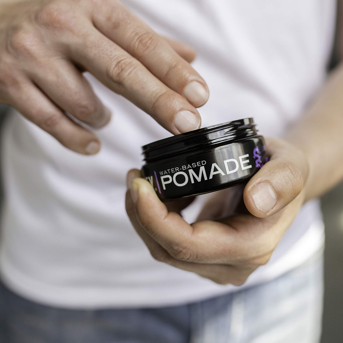  Billy Jealousy Lunatic Fringe hands applying pomade for smooth, controlled styling.