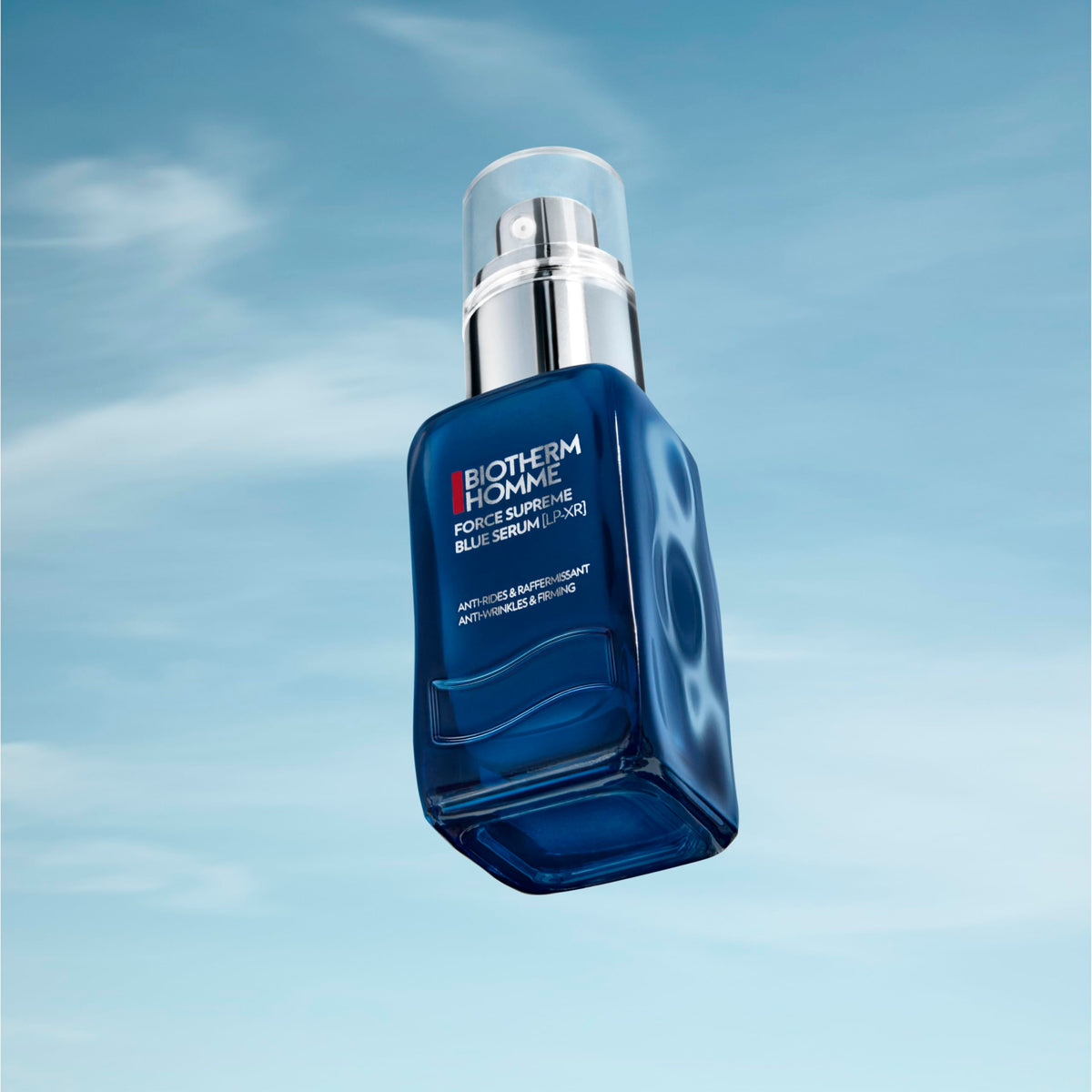 Biotherm bottle next to coin to show 2 fl oz scale and travel-friendly convenience