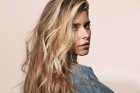 Close-up of BlondMe bottle emphasizing bond repair for stronger hair.