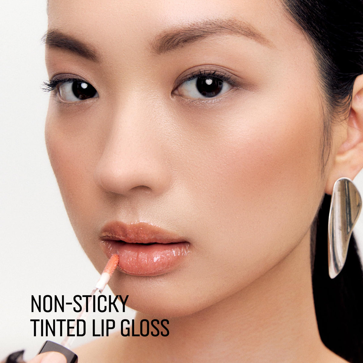 Lip swatch of Bobbi Brown Crushed Oil-Infused Gloss shows sheer shimmer