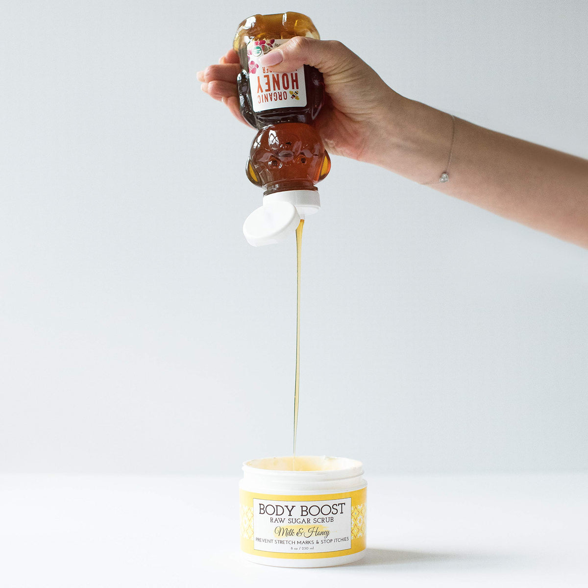 Body Boost Milk & Honey Sugar Scrub being applied to skin for exfoliation