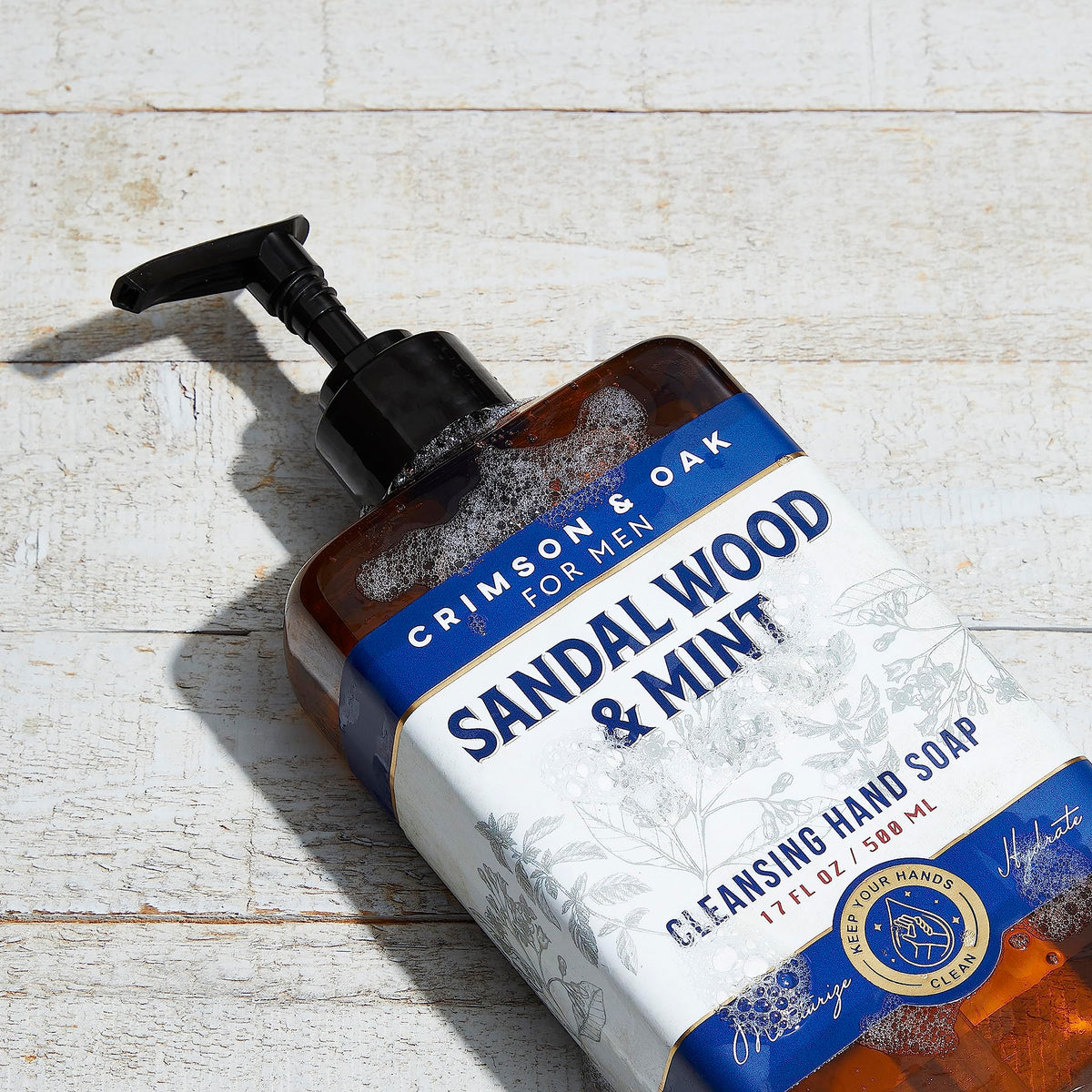 Body Prescriptions Crimson & Oak hand soap pump close-up showing dispensing action.