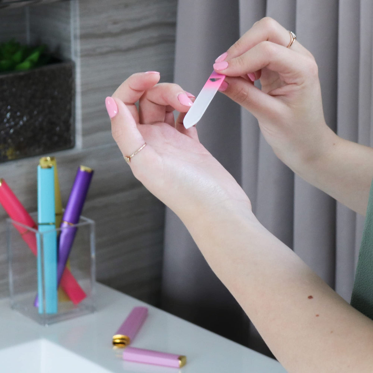 Cleaning a glass nail file under cold water after use