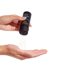 Bondi Sands Self Tan Drying Powder bottle on surface illustrates crease prevention and finish.