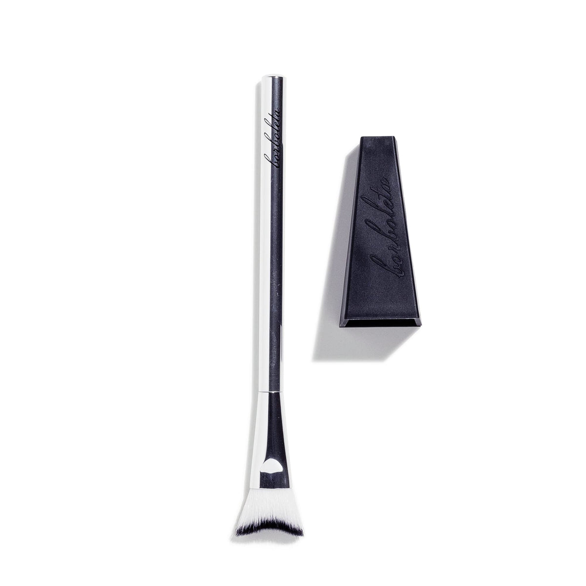 Borboleta Clean Swoop Brush hugs the lash line for gentle makeup removal.