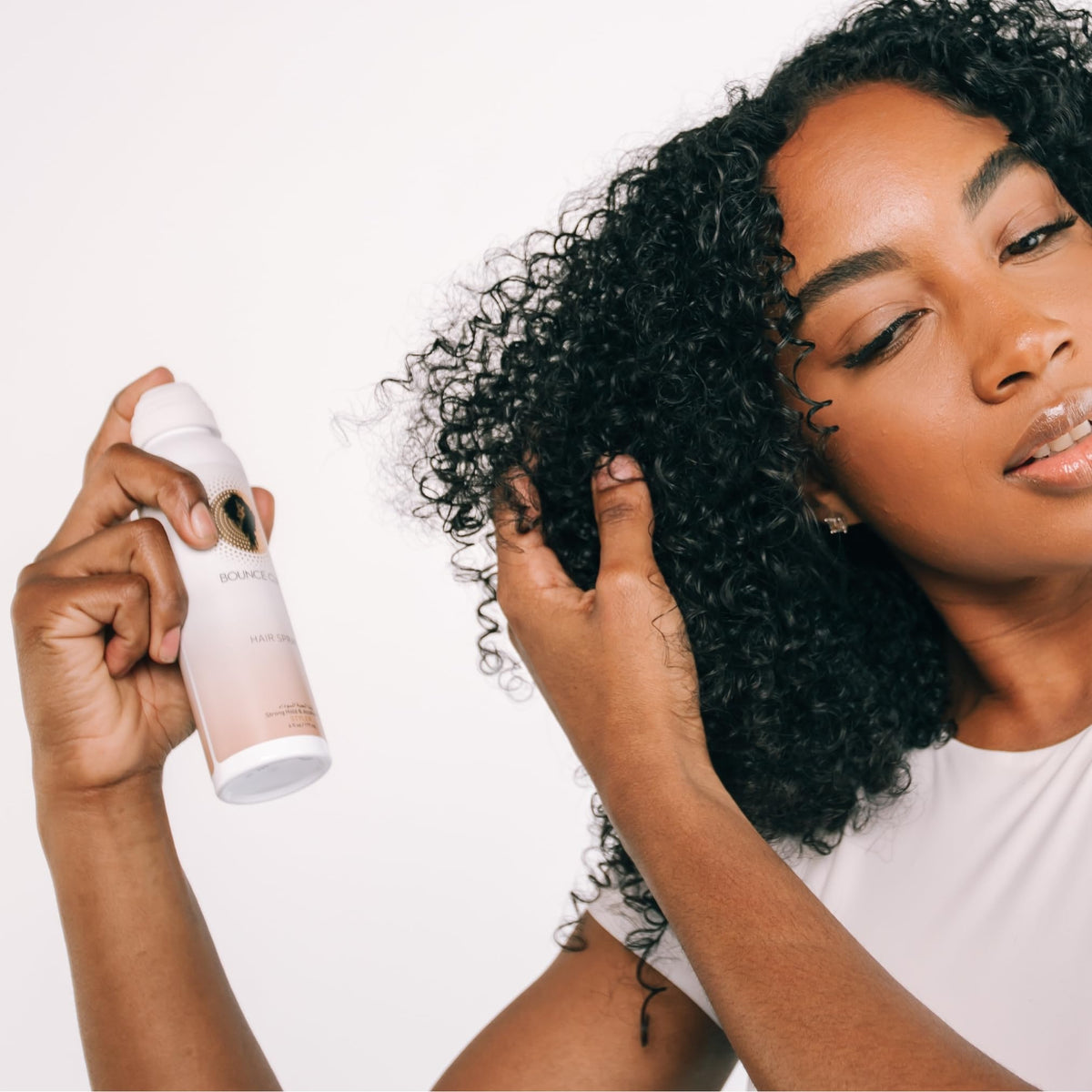 Bounce Curl Alcohol-Free Strong Hold HairSpray packaging highlights clean travel-friendly design.