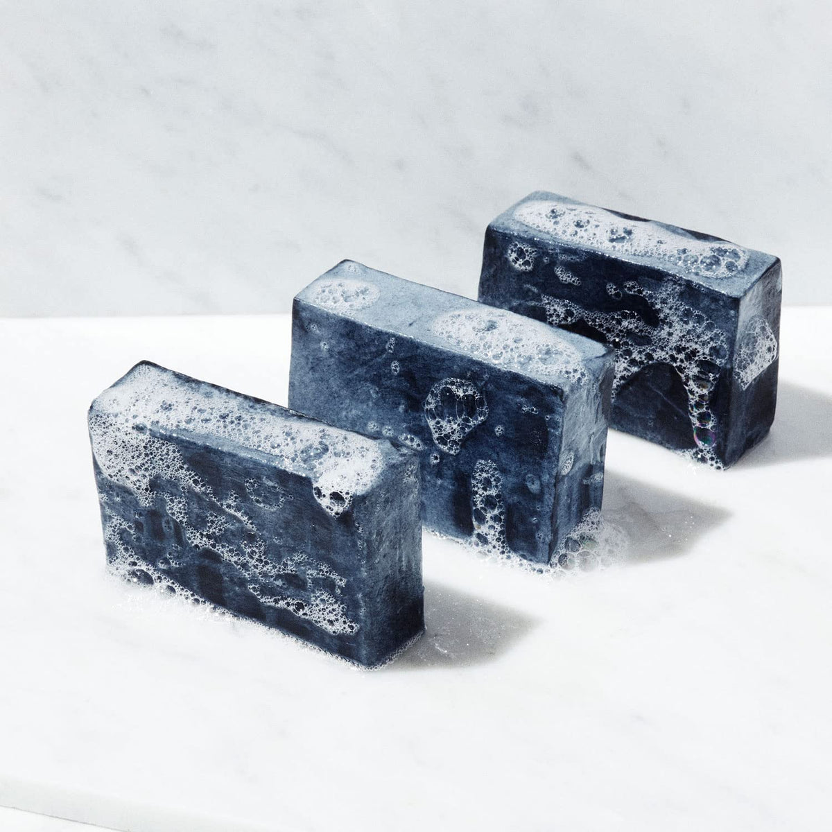 Brickell Men's Purifying Charcoal Soap Bar lather closeup with minty scent.