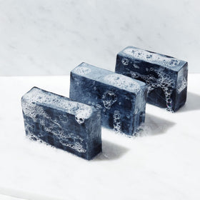Brickell Men's Purifying Charcoal Soap Bar lather closeup with minty scent.