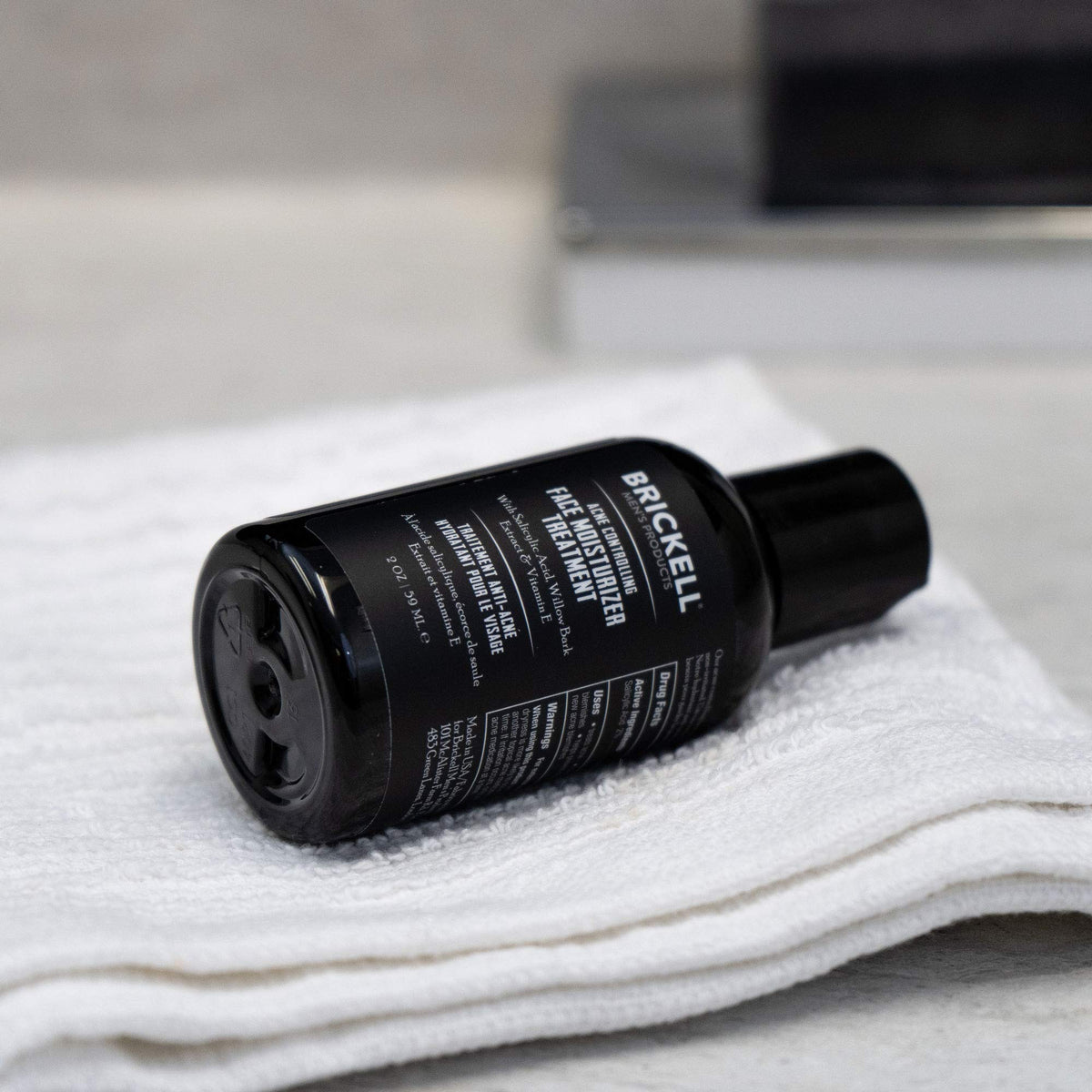 Brickell Men's Acne Moisturizer dispensing pump closeup emphasizing easy daily use.