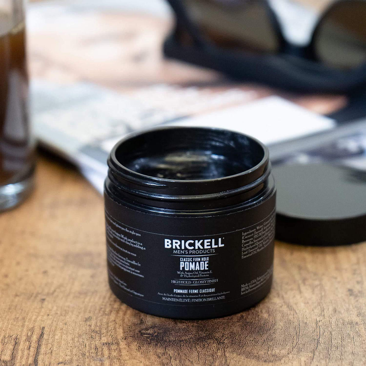 Close-up of pomade jar label emphasizing natural and organic ingredients