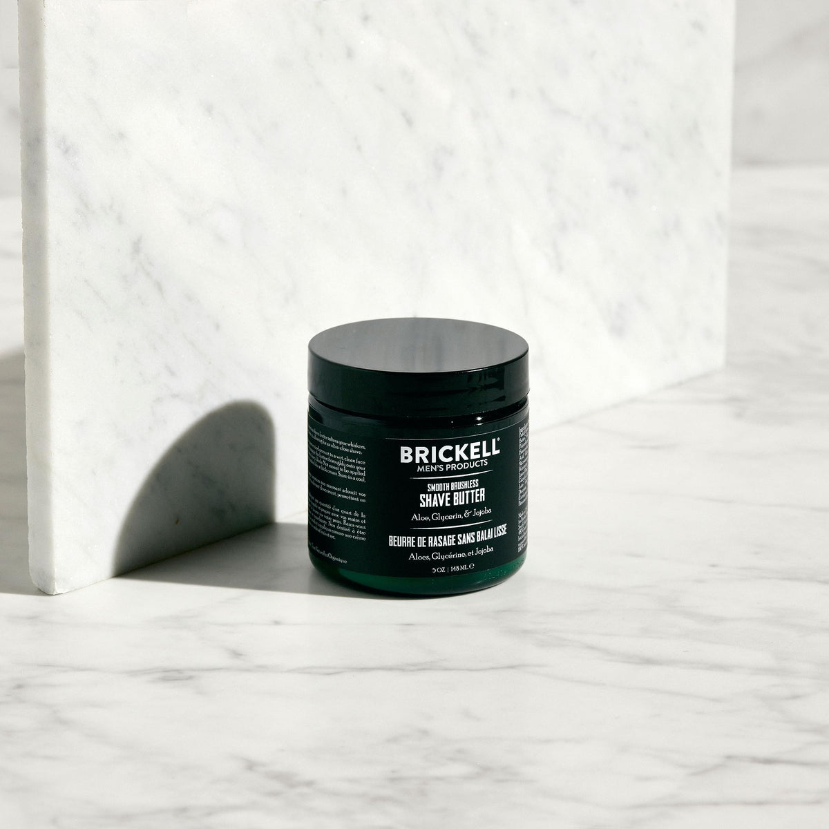 Brickell Men's shave butter application on face delivering even spread and comfortable glide