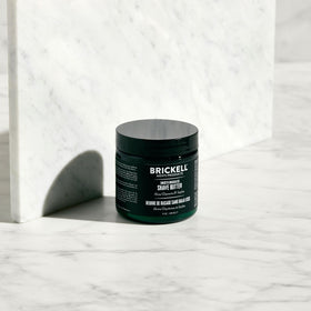 Brickell Men's shave butter application on face delivering even spread and comfortable glide