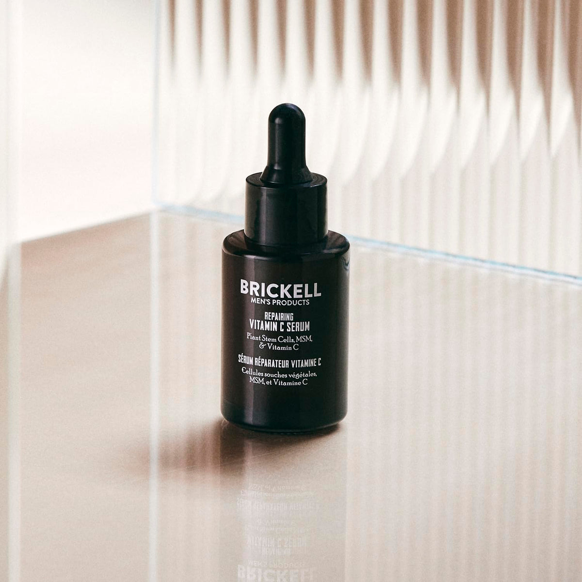 Brickell Men's vitamin C serum dispense action showing easy pump for nightly routine.