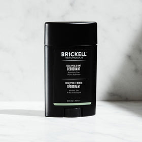 Applying Brickell deodorant underarm for long-lasting odor control