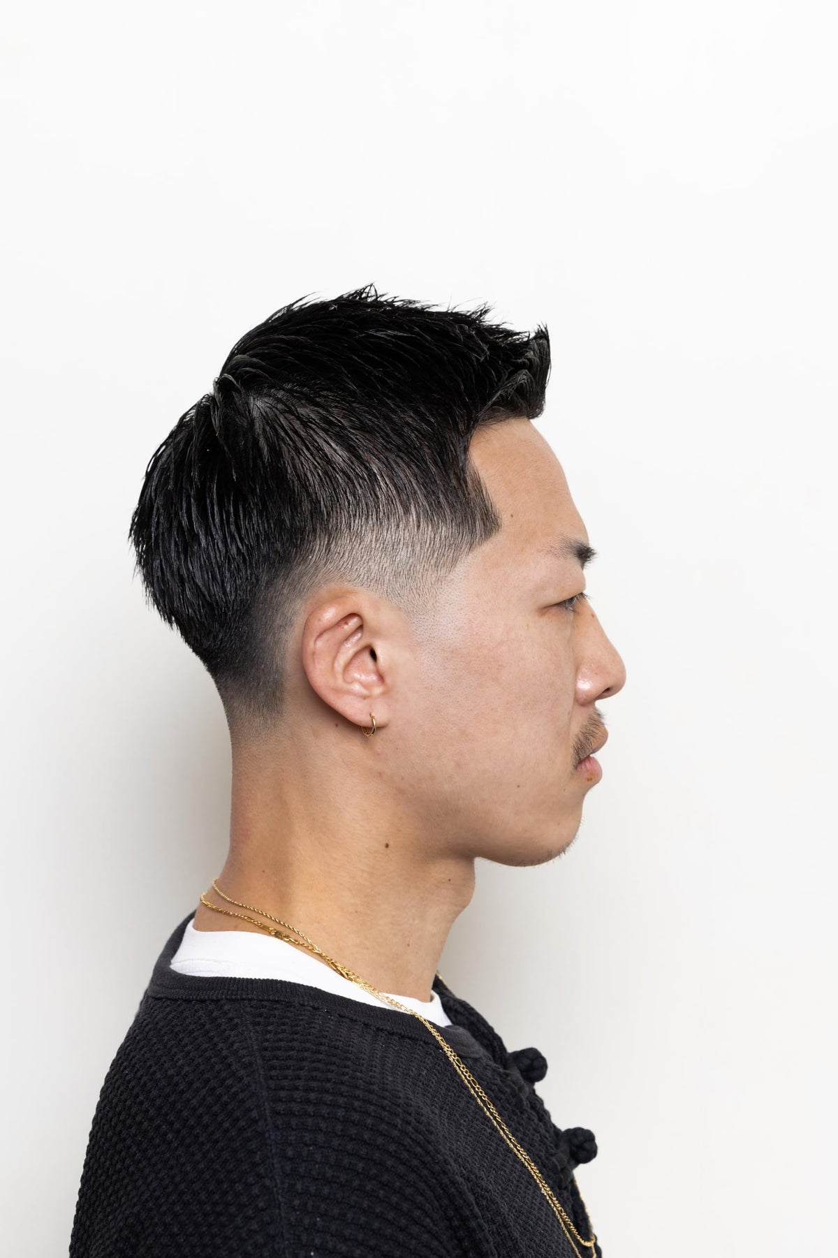 Hands applying BROSH Hard Pomade for effortless styling.