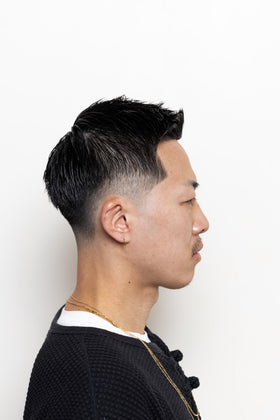Hands applying BROSH Hard Pomade for effortless styling.