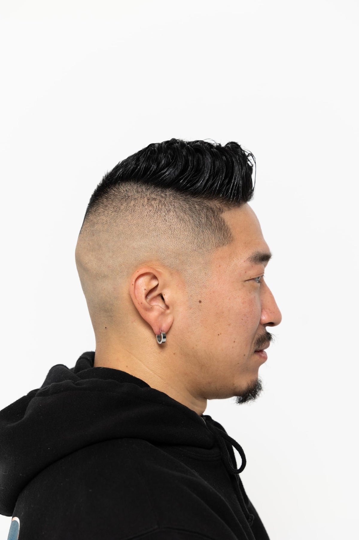 Hands applying BROSH Pomade for modern, flexible hold