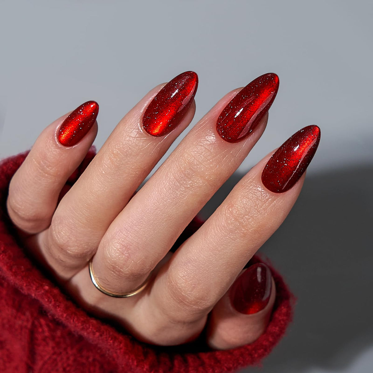 BTArtbox almond nails in deep red sparkle with glossy finish, close-up