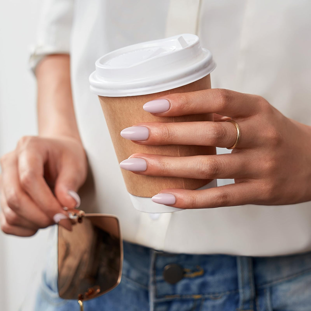 Nails being applied with glue for at-home salon-quality results