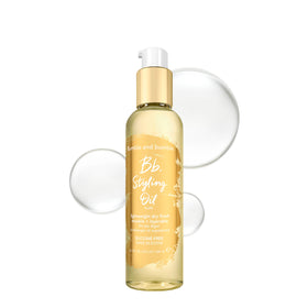 Bumble and bumble Styling Oil bottle pour shows easy application for silky, frizz-free hair.