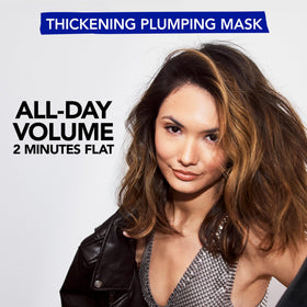 Bumble and bumble Thickening Plumping Mask application hand pose demonstrates detangling ease.