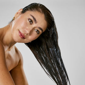 Bumble and bumble Hair Mask application on hair seals frizz protection.