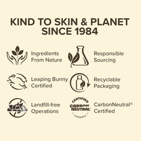 Hands applying Burt's Bees Milk and Honey lotion on skin.