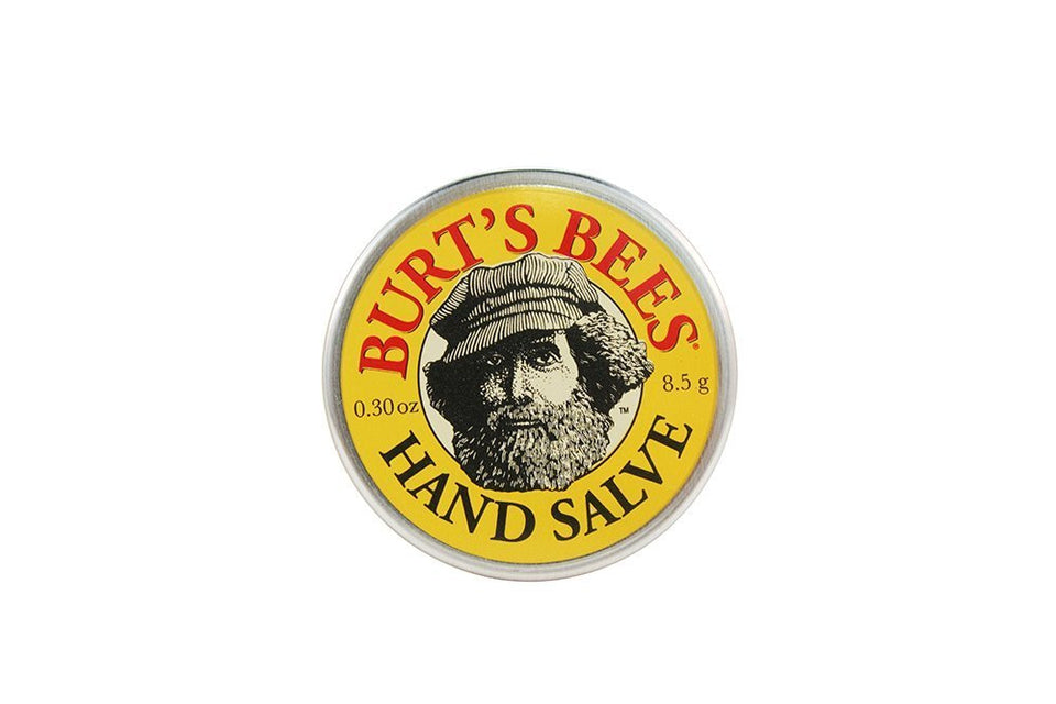 Burt's Bees Mini Hand Salve tin in a purse for on-the-go moisture.