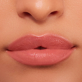 BUXOM Power-Full Lip Balm Inner Glow creamy texture on fingertip.