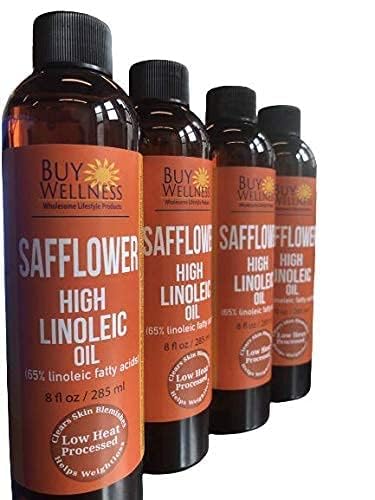 Buy Wellness safflower oil poured into hand for quick, light skin absorption.