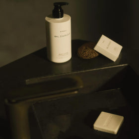 Lifestyle shot shows a hotel-inspired bathroom setup with Bal D'Afrique shampoo for premium care.