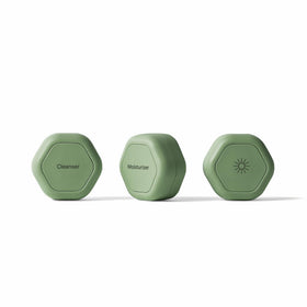 Cadence travel capsules with magnetic lids show organized skincare on the go.