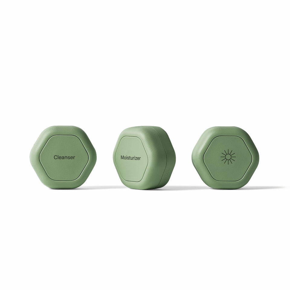 Cadence travel capsules with magnetic lids show organized skincare on the go.