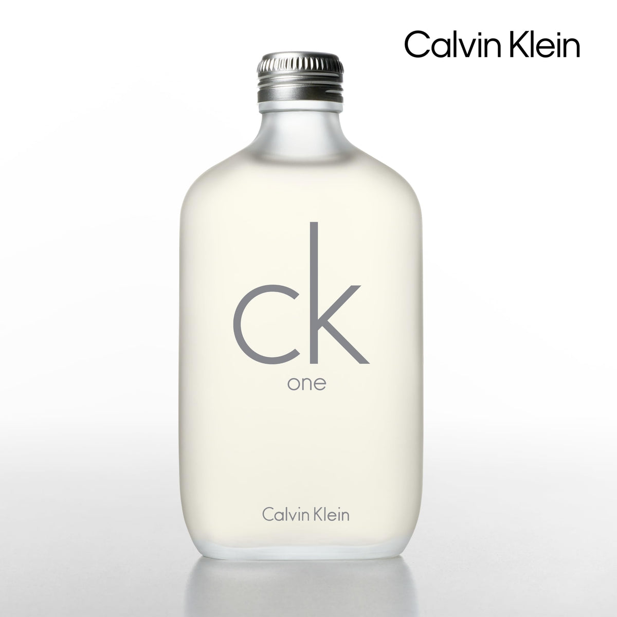 Calvin Klein CK One bottle closeup highlights citrus and green tea notes.