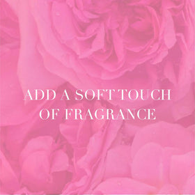 Camille Beckman rosewater powder application on hand for gentle fragrance.