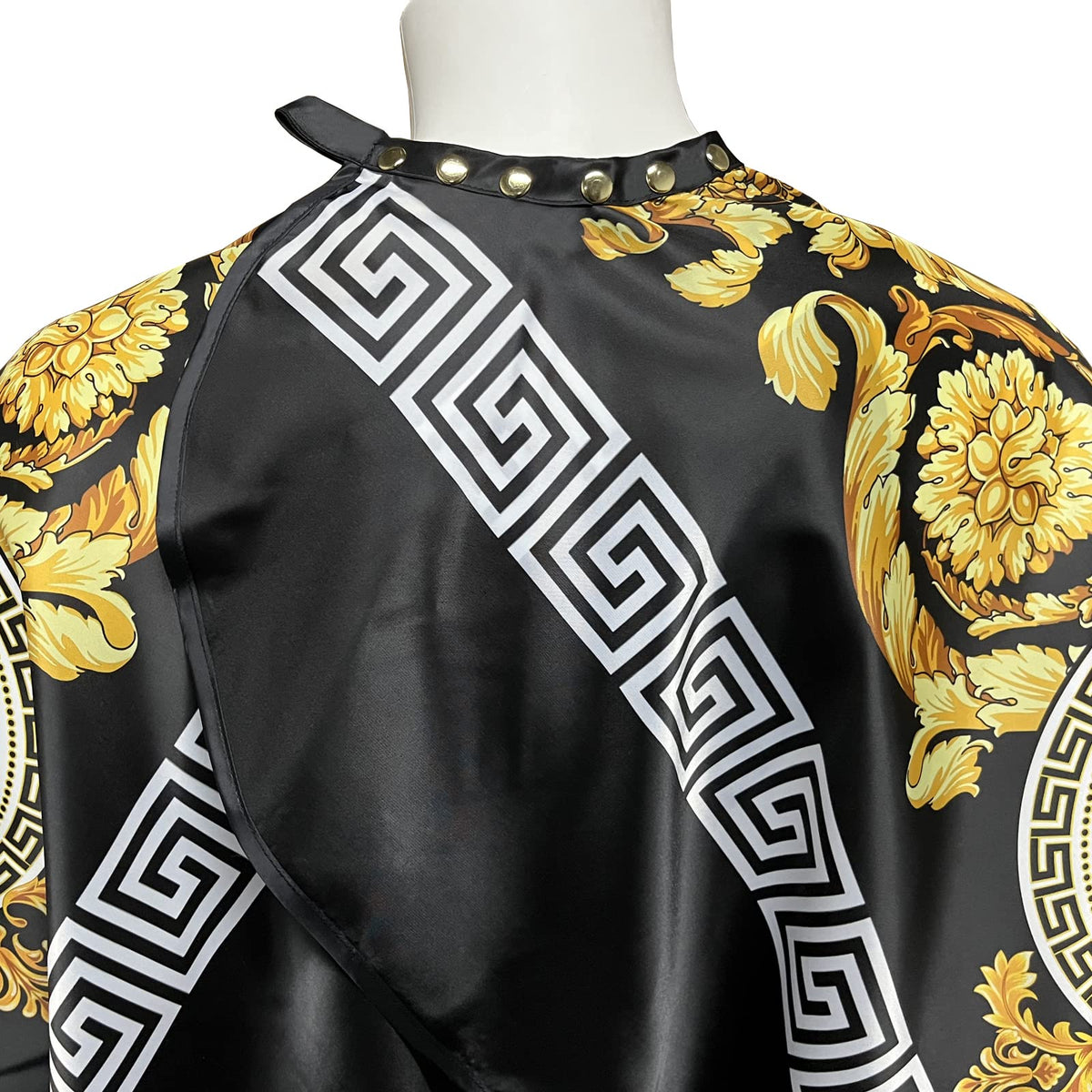 CapeshionPro cape shows adjustable neck snaps for secure fitting.