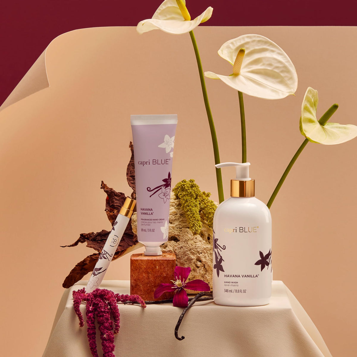 Capri Blue Flora Edit bottle close-up with white packaging and gold detailing