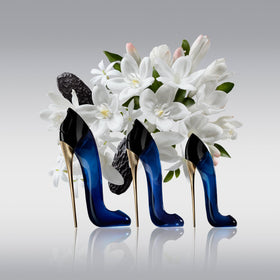 Carolina Herrera Good Girl glass bottle catching light for luxe display.