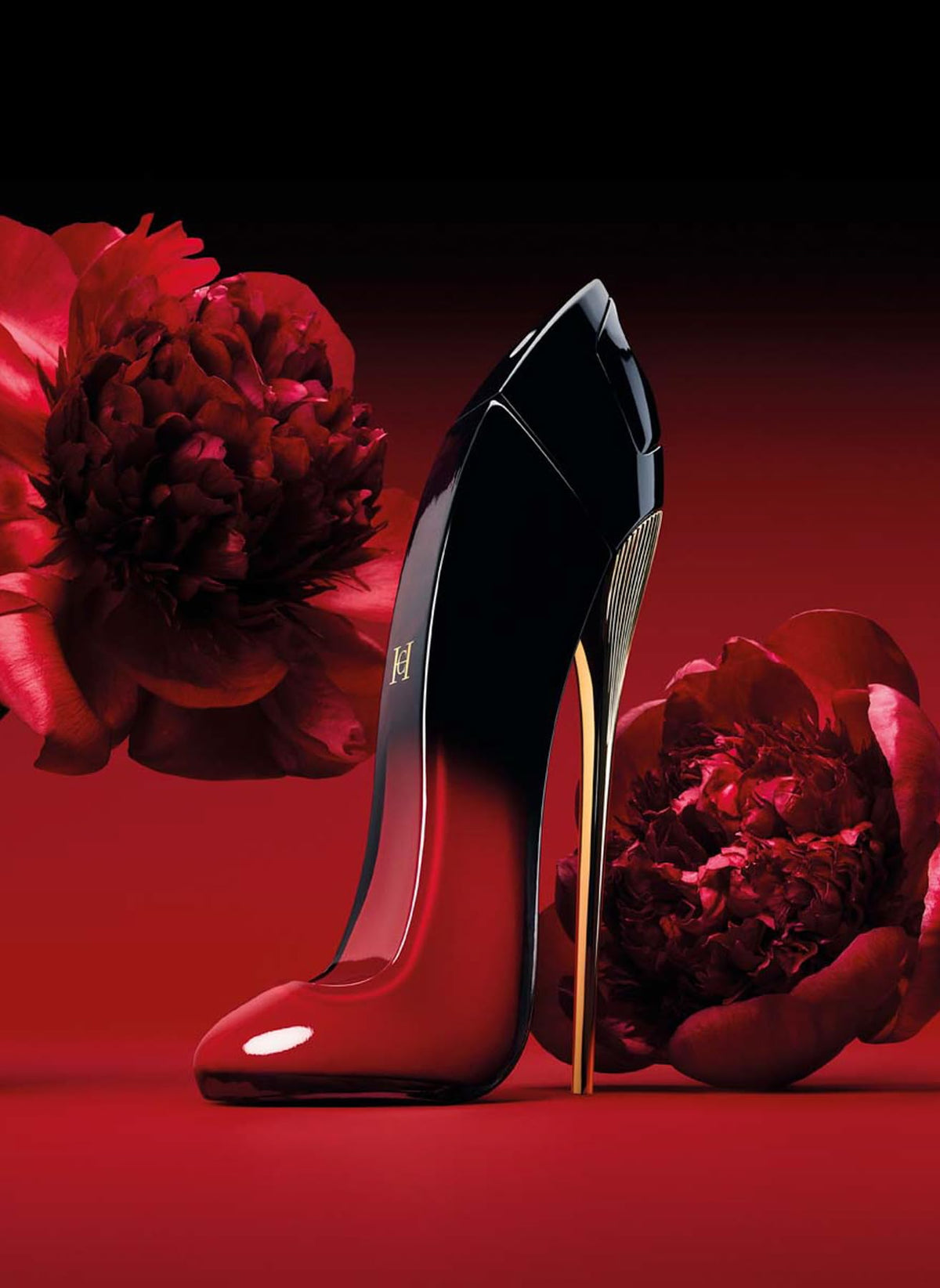 Carolina Herrera Very Good Girl Elixir bottle glow on a marble surface