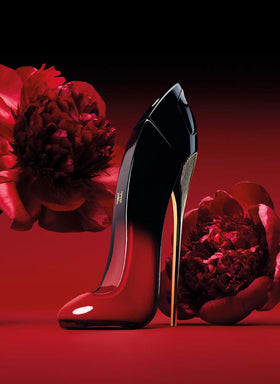 Carolina Herrera Very Good Girl Elixir bottle glow on a marble surface